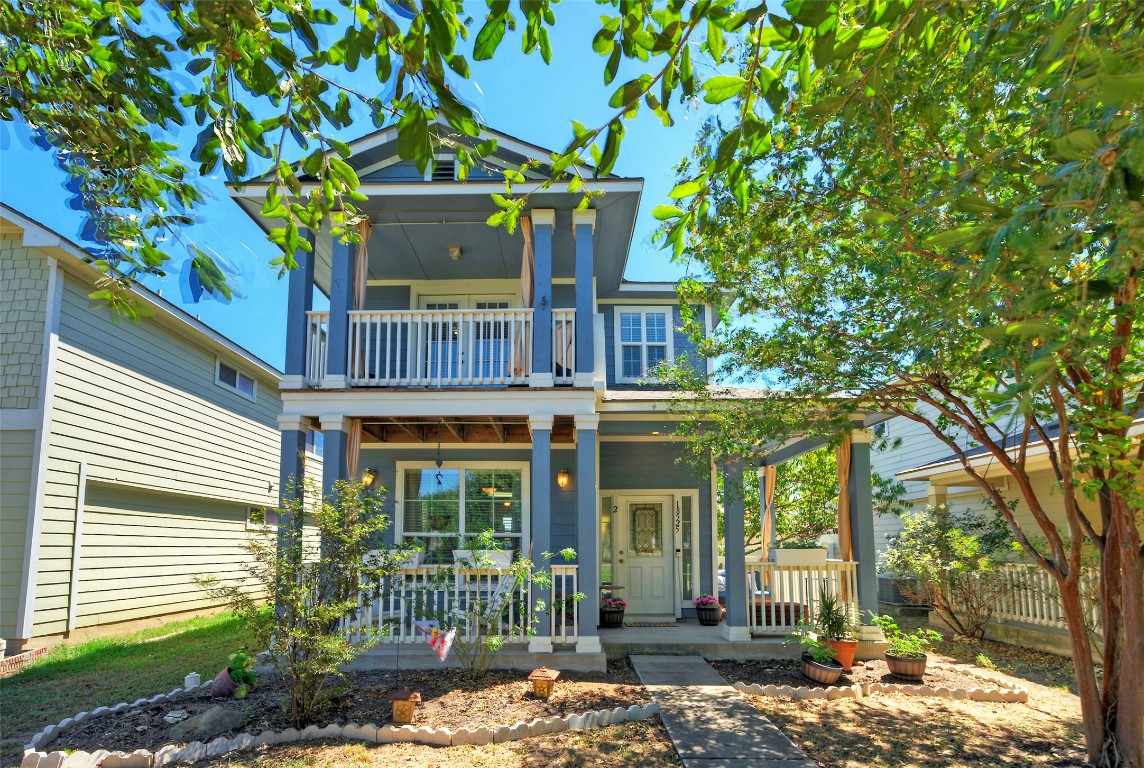 a view of a house with a tree in front