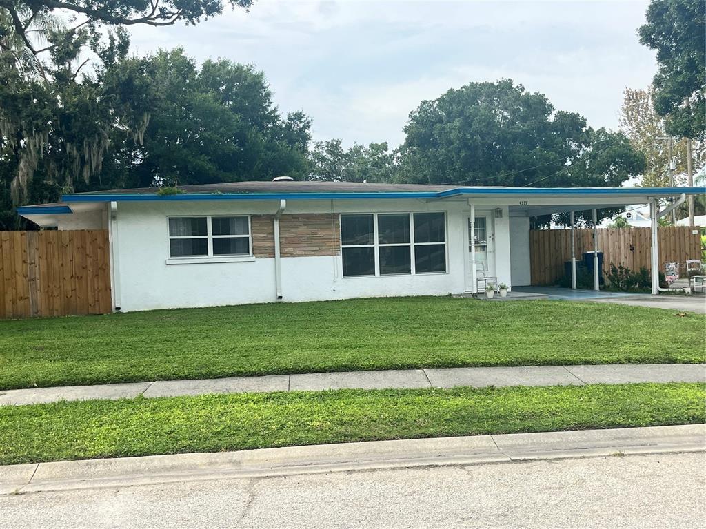 a view of a house with a backyard