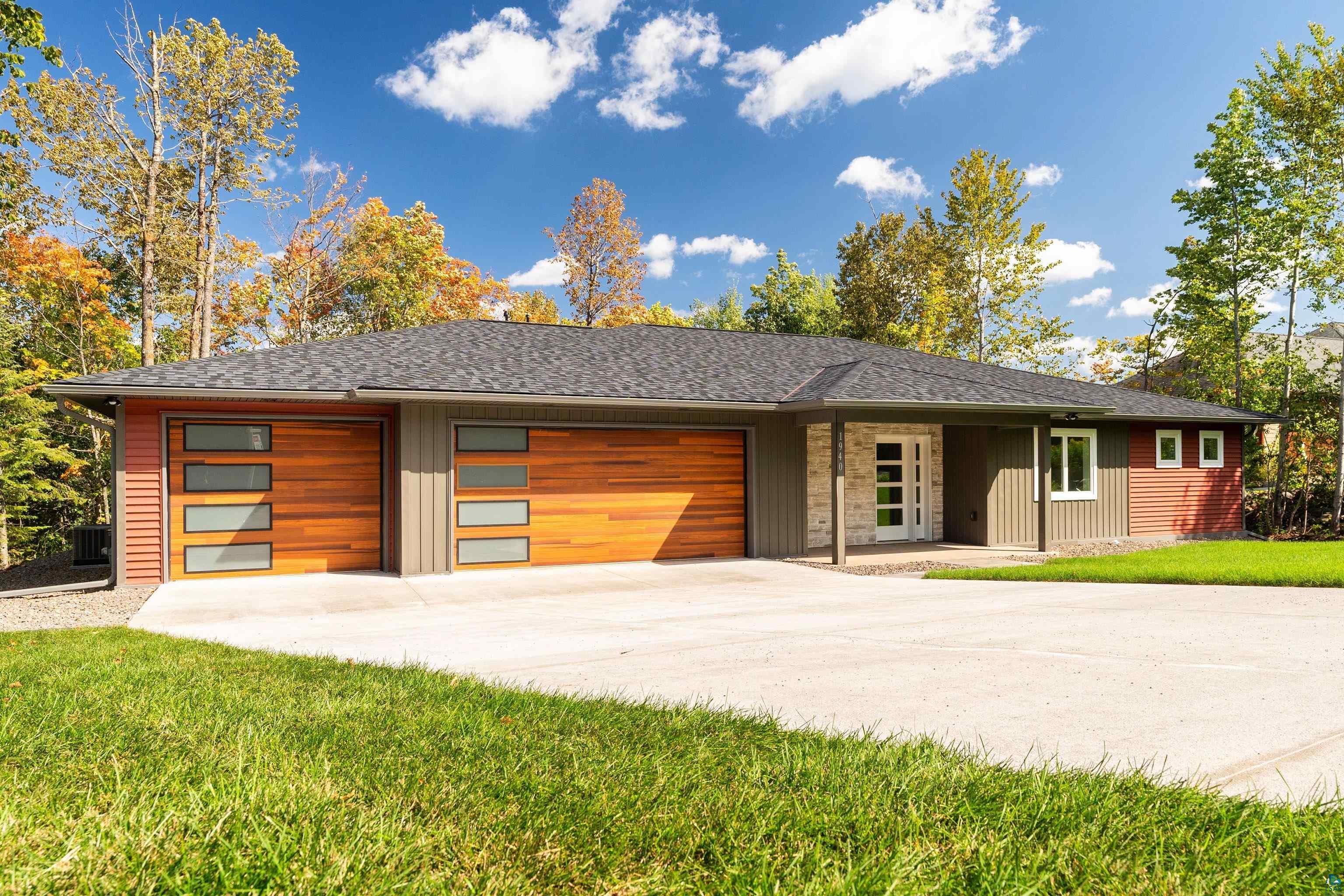 View of front of house with a garage and a front yard