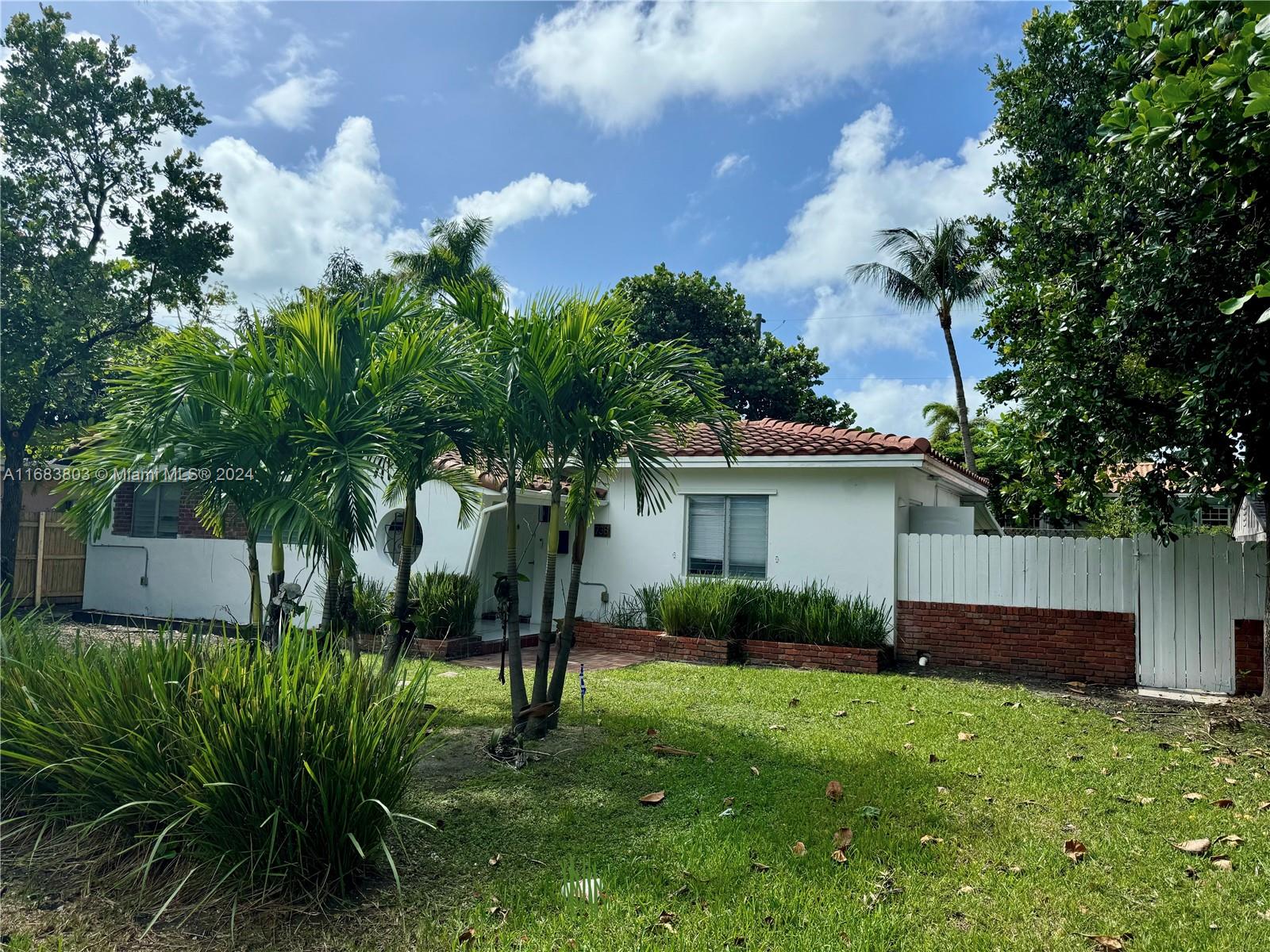 a view of backyard of house with green space