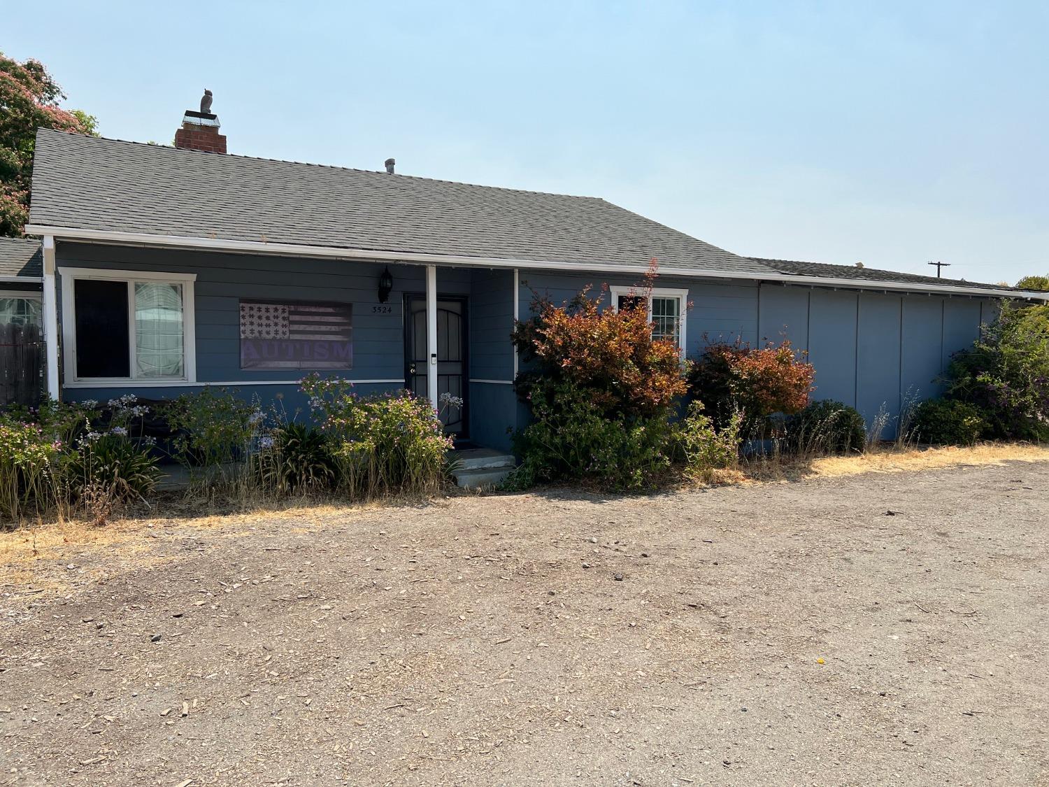 a front view of a house with garden