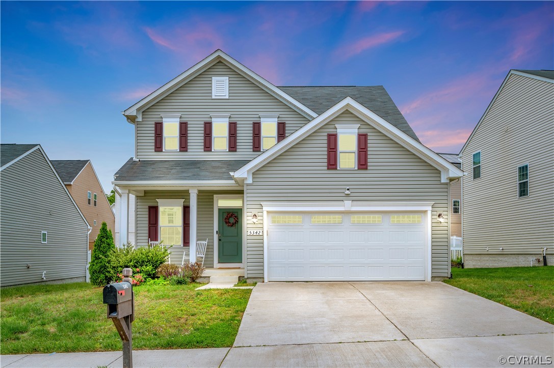 a front view of a house with a yard and garage