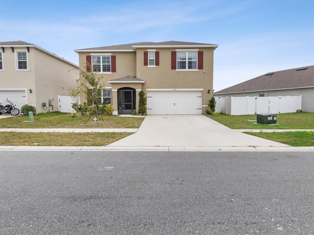 a front view of a house with a yard and garage