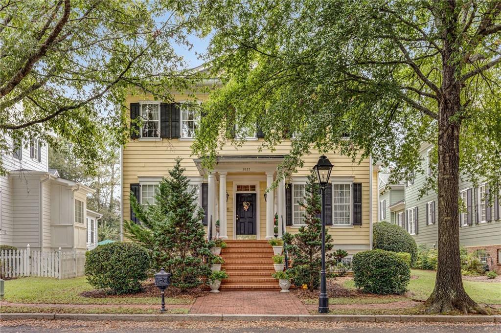 a front view of a house with a tree