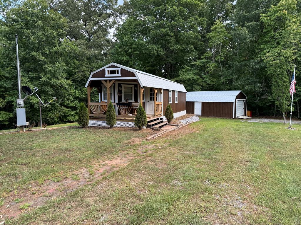 a view of a house with a backyard