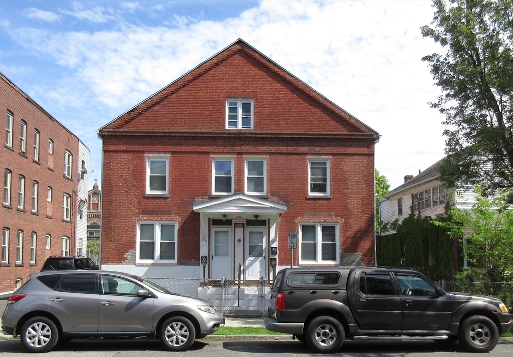 a front view of a house with parking space