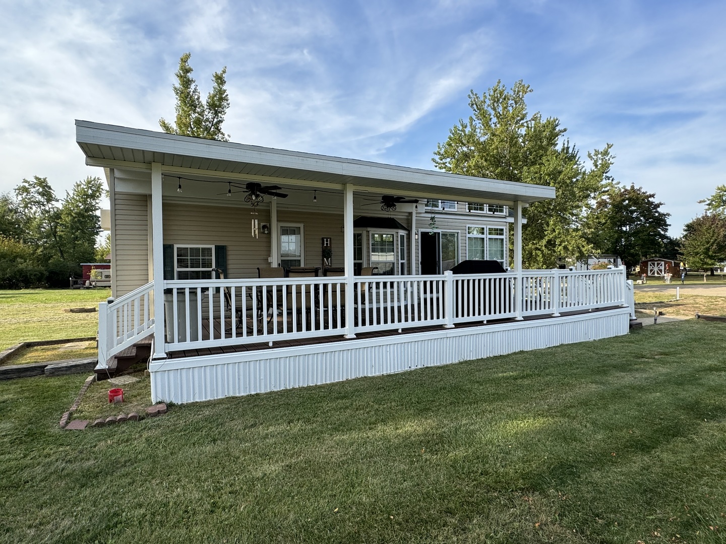 a view of a house with a deck and a yard