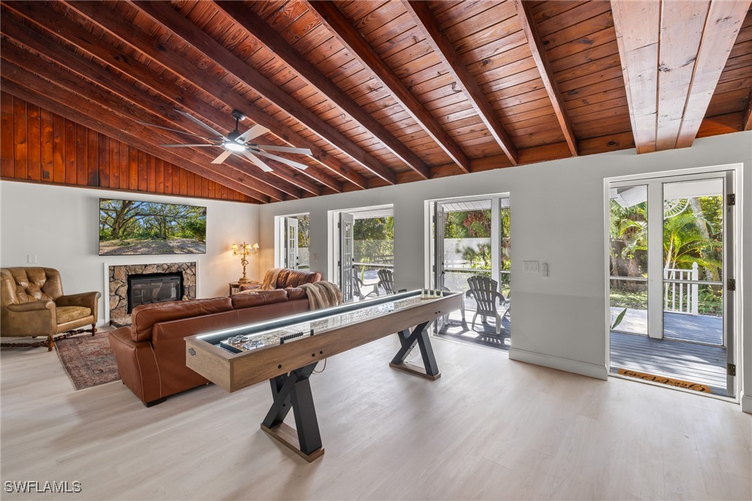 a room with furniture pool table gym equipment and windows