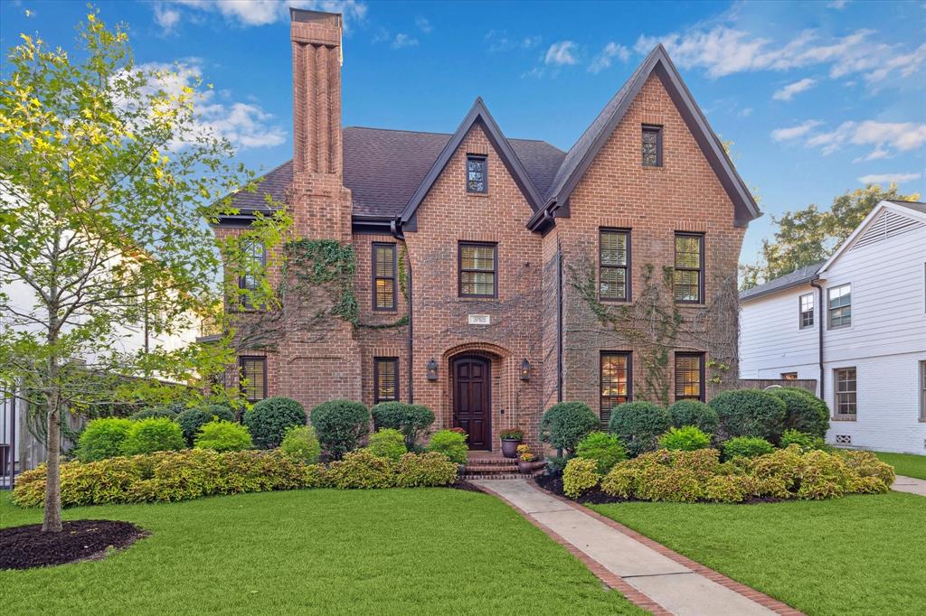 Timelessly charming English Tudor inspired home w/stately ALL BRICK exterior, prominently placed chimney w/intricate accents & understated details.