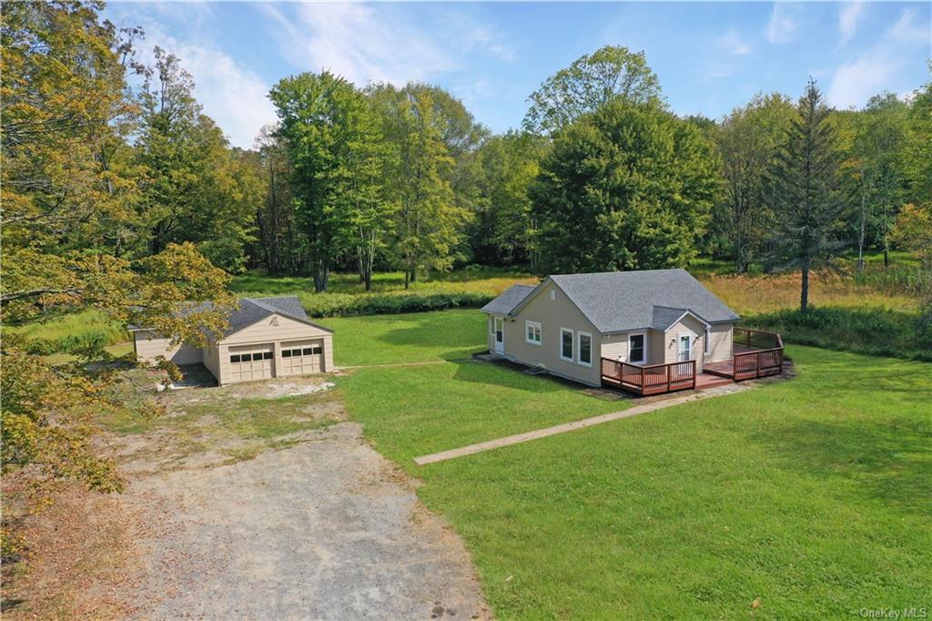 an aerial view of a house with backyard garden and trees