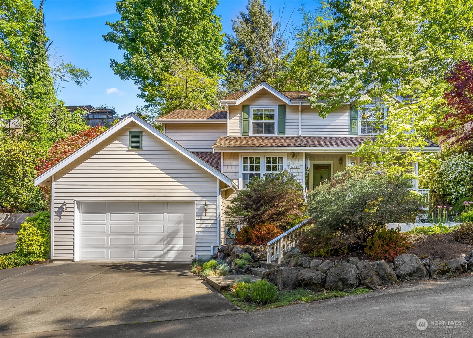 a front view of a house with a yard and garage