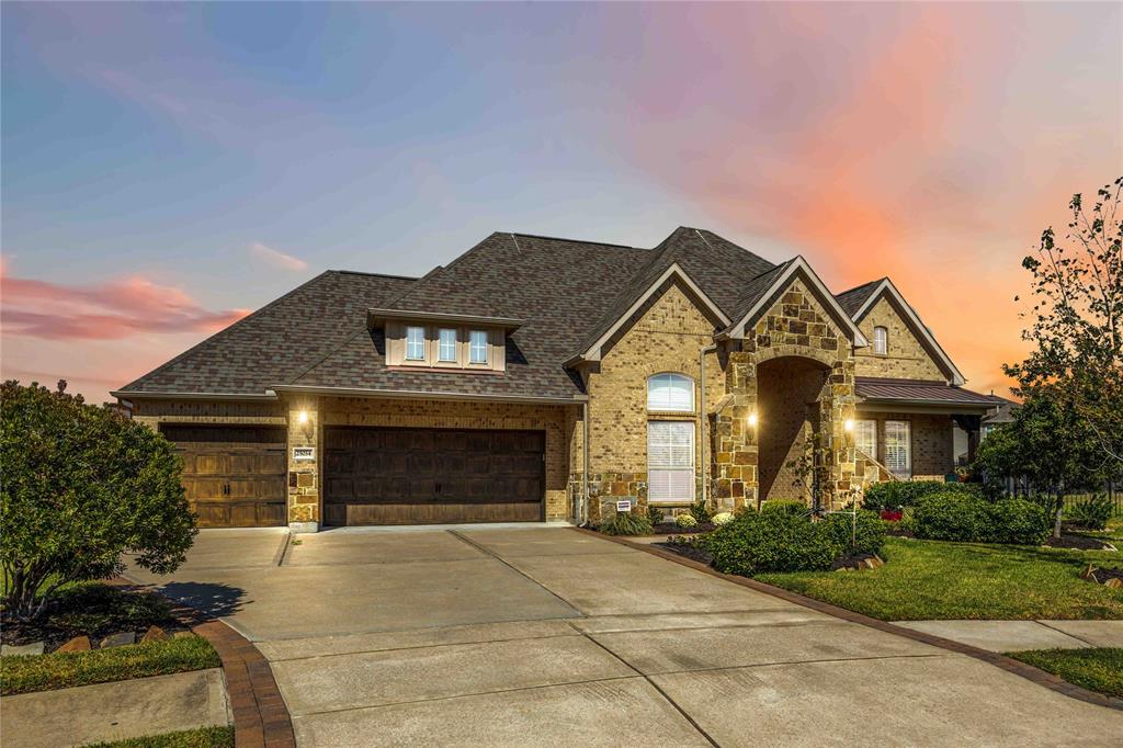 a front view of a house with a yard and garage