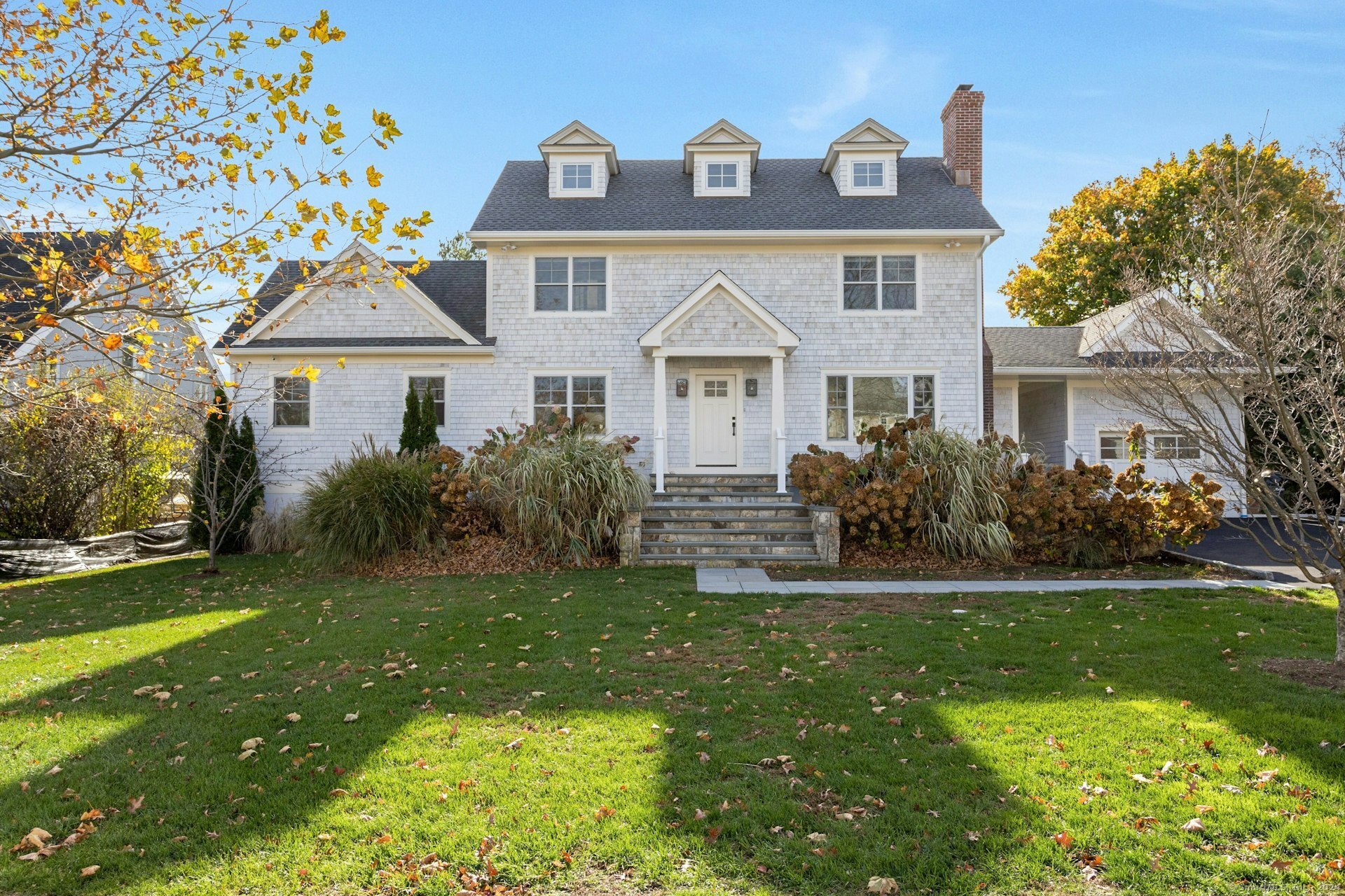 a front view of a house with a garden