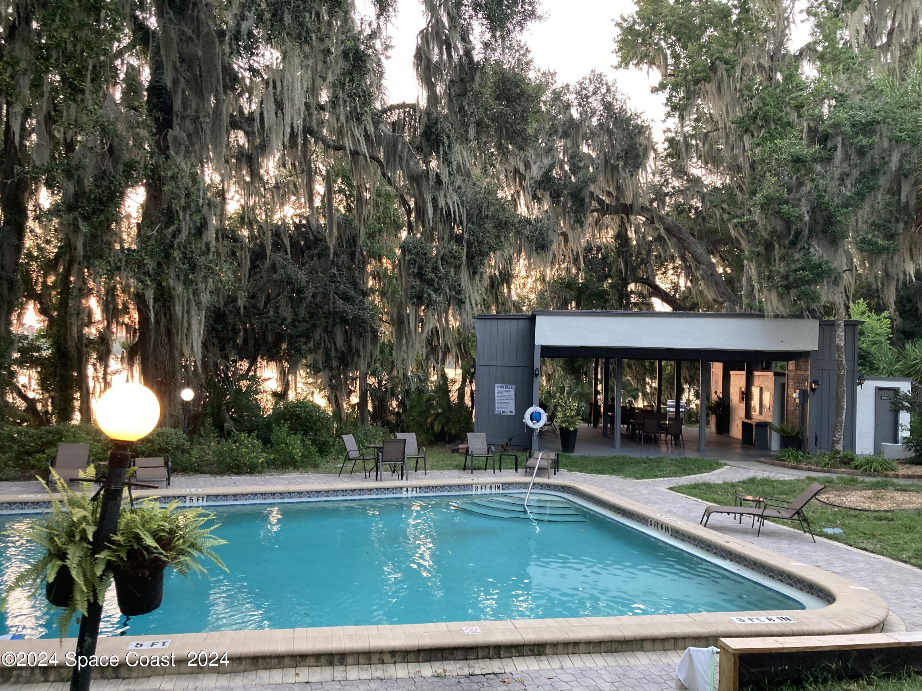 a view of a house with swimming pool and sitting area