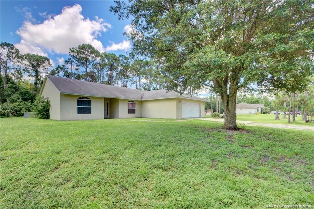 a view of a house with yard and tree s