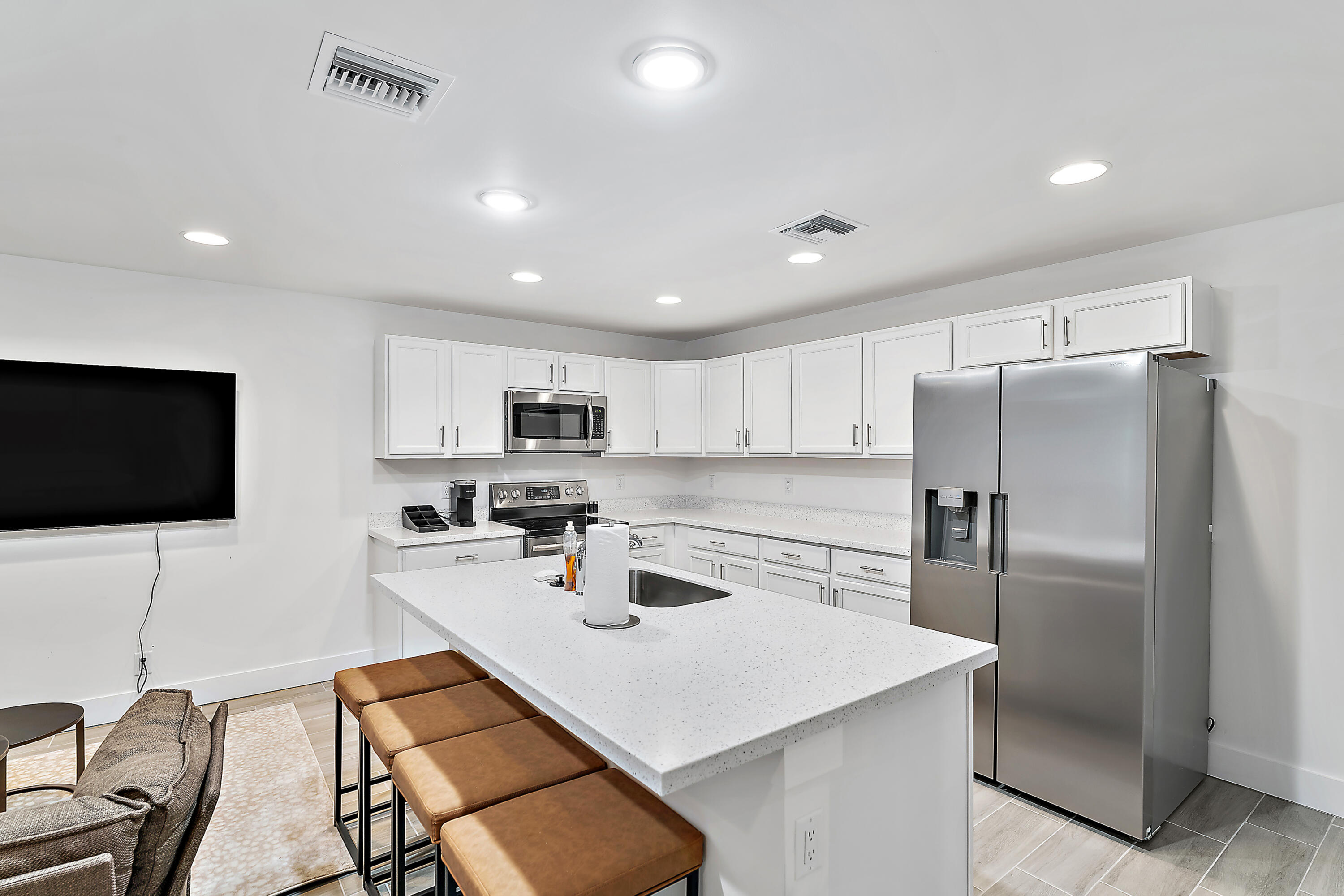 a kitchen with kitchen island a appliances dining table and chairs