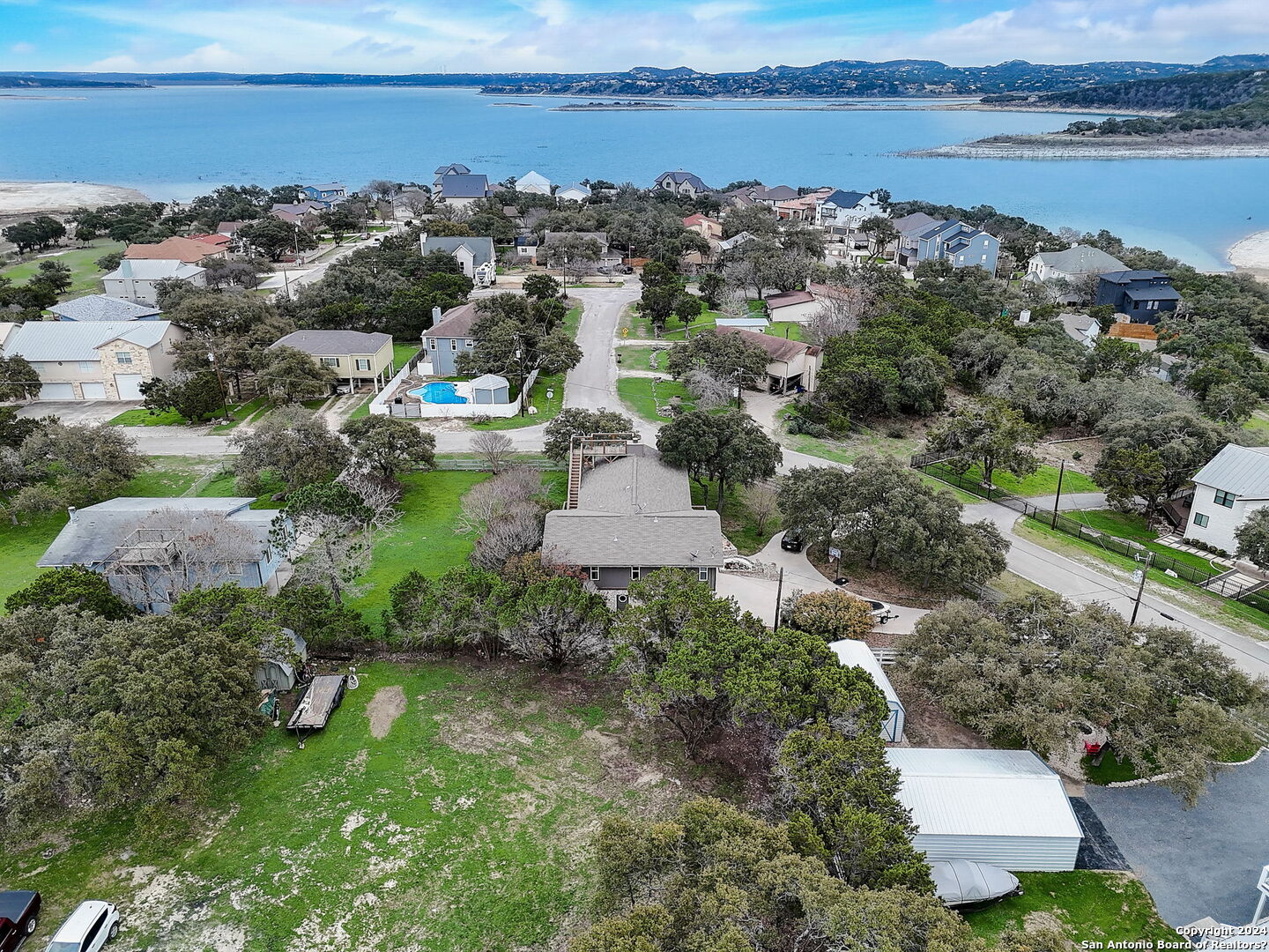 an aerial view of a houses with outdoor space and lake view