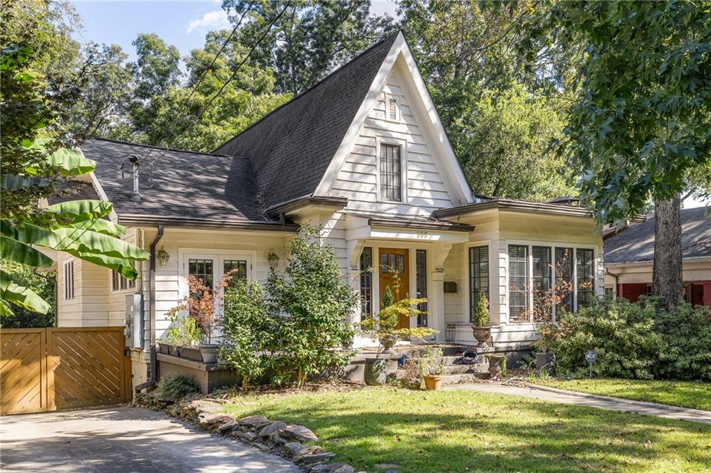 a view of a brick house with a yard patio and a table and chairs