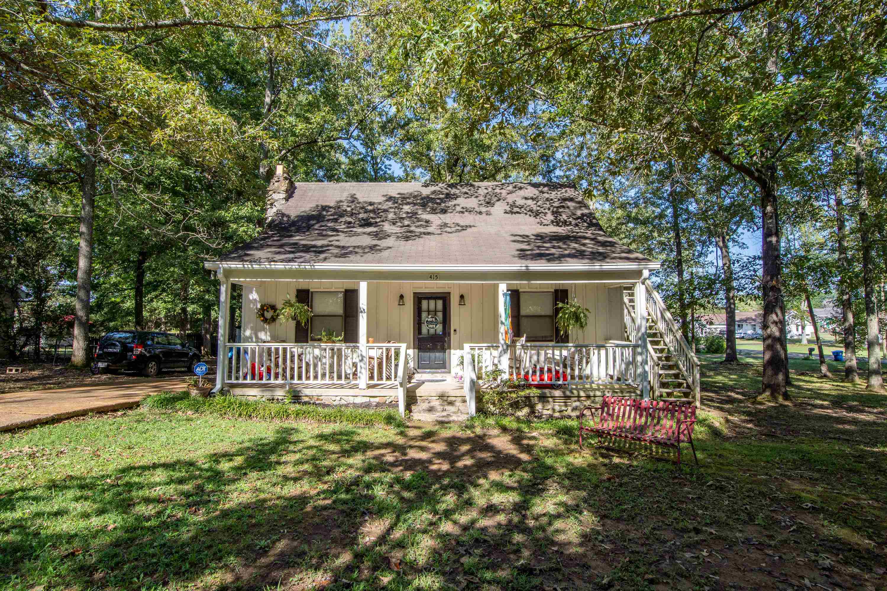 a front view of house with a garden