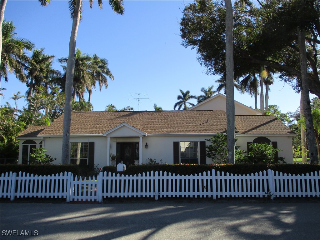 a view of a house with a fence