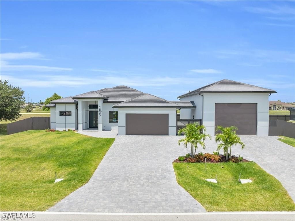 a front view of a house with a garden and yard