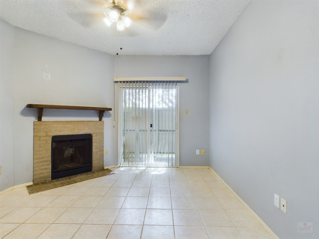 a view of an empty room with a fireplace