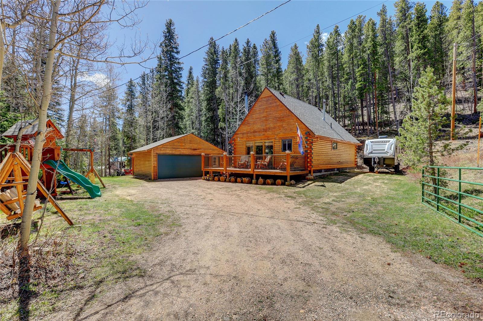 a view of a house with a yard and a wooden deck