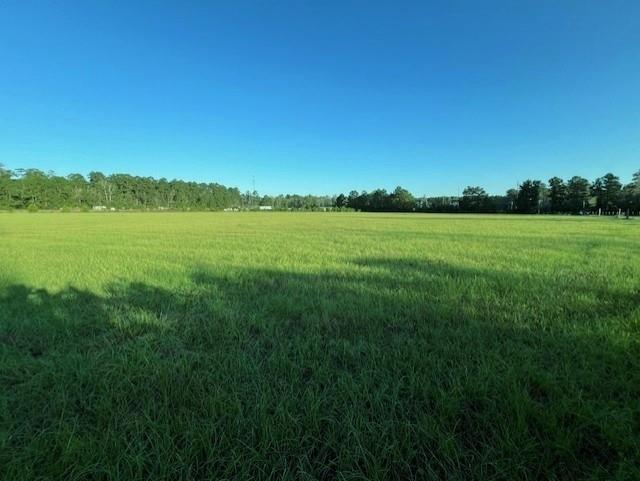 a view of a lake and green valley