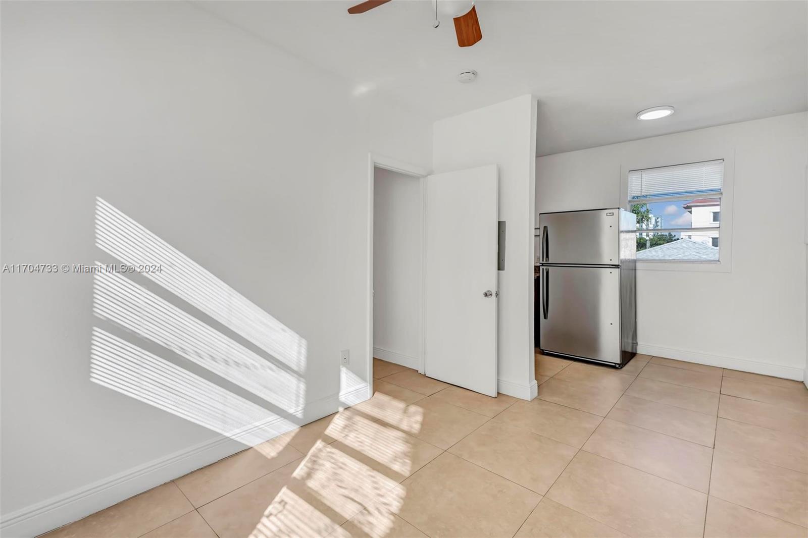 a view of kitchen and refrigerator