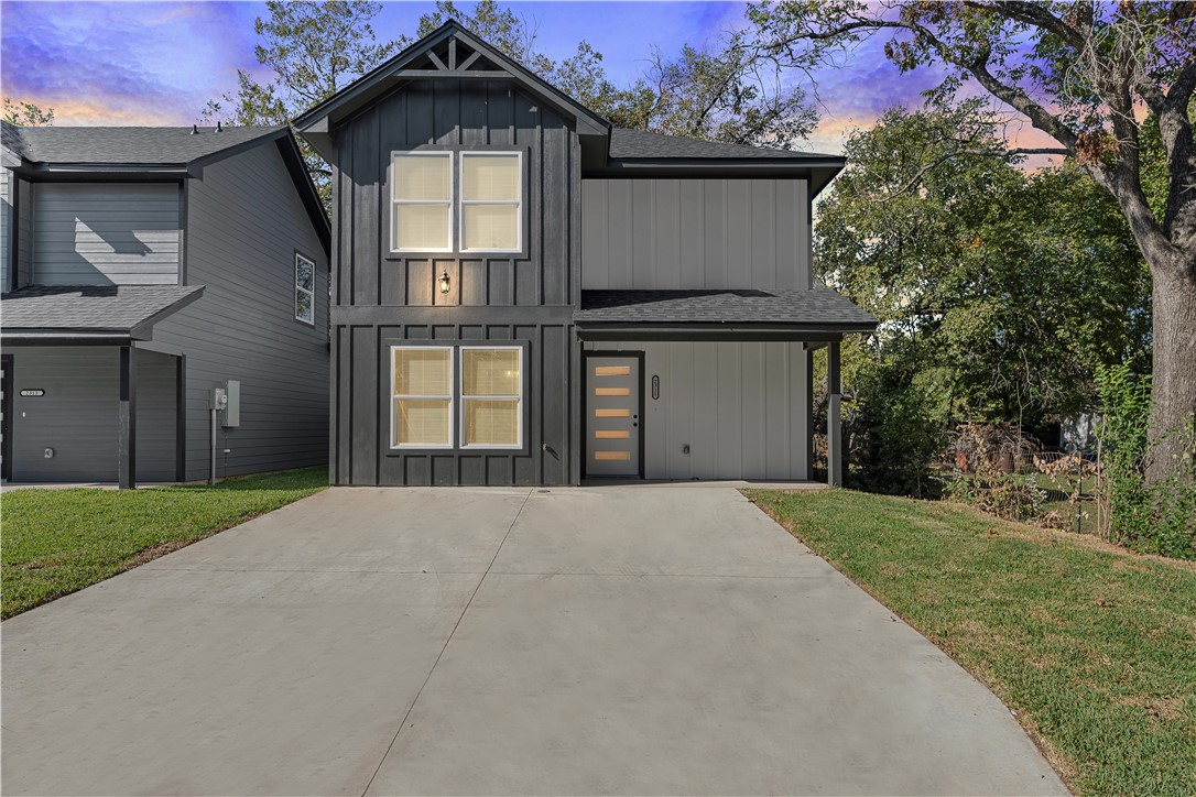 a front view of a house with a yard and garage