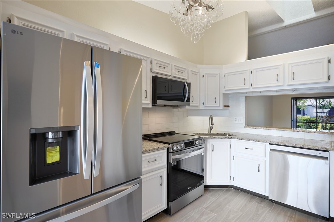 a kitchen with stainless steel appliances a white stove top oven and sink