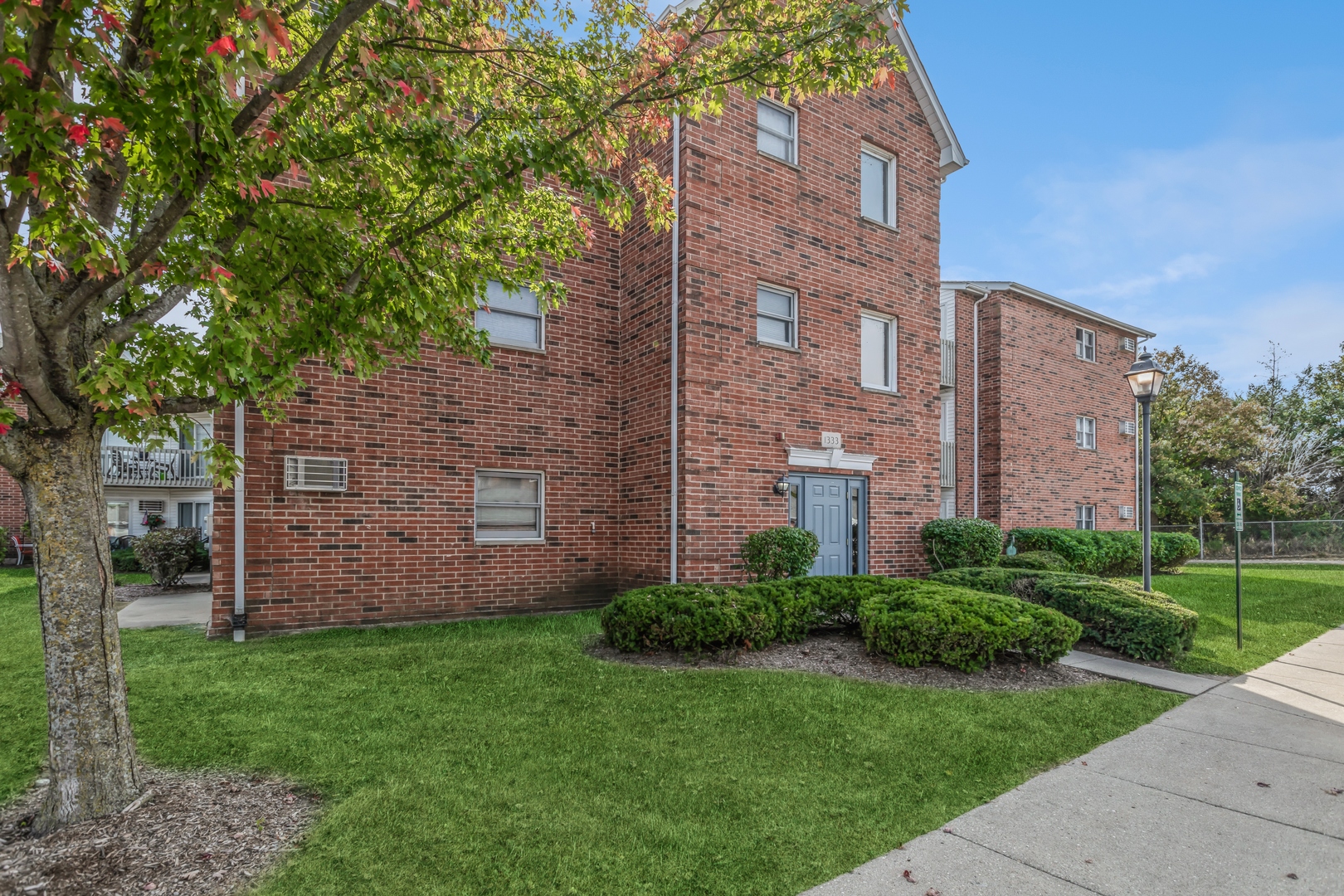 a brick building with a yard