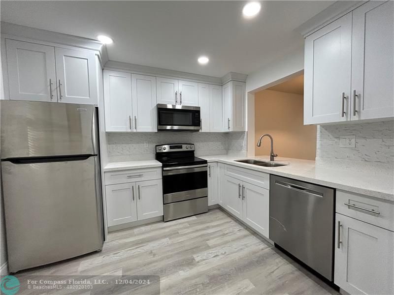 a kitchen with a refrigerator and a sink