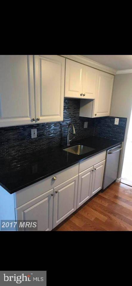 a bathroom with a sink and cabinets