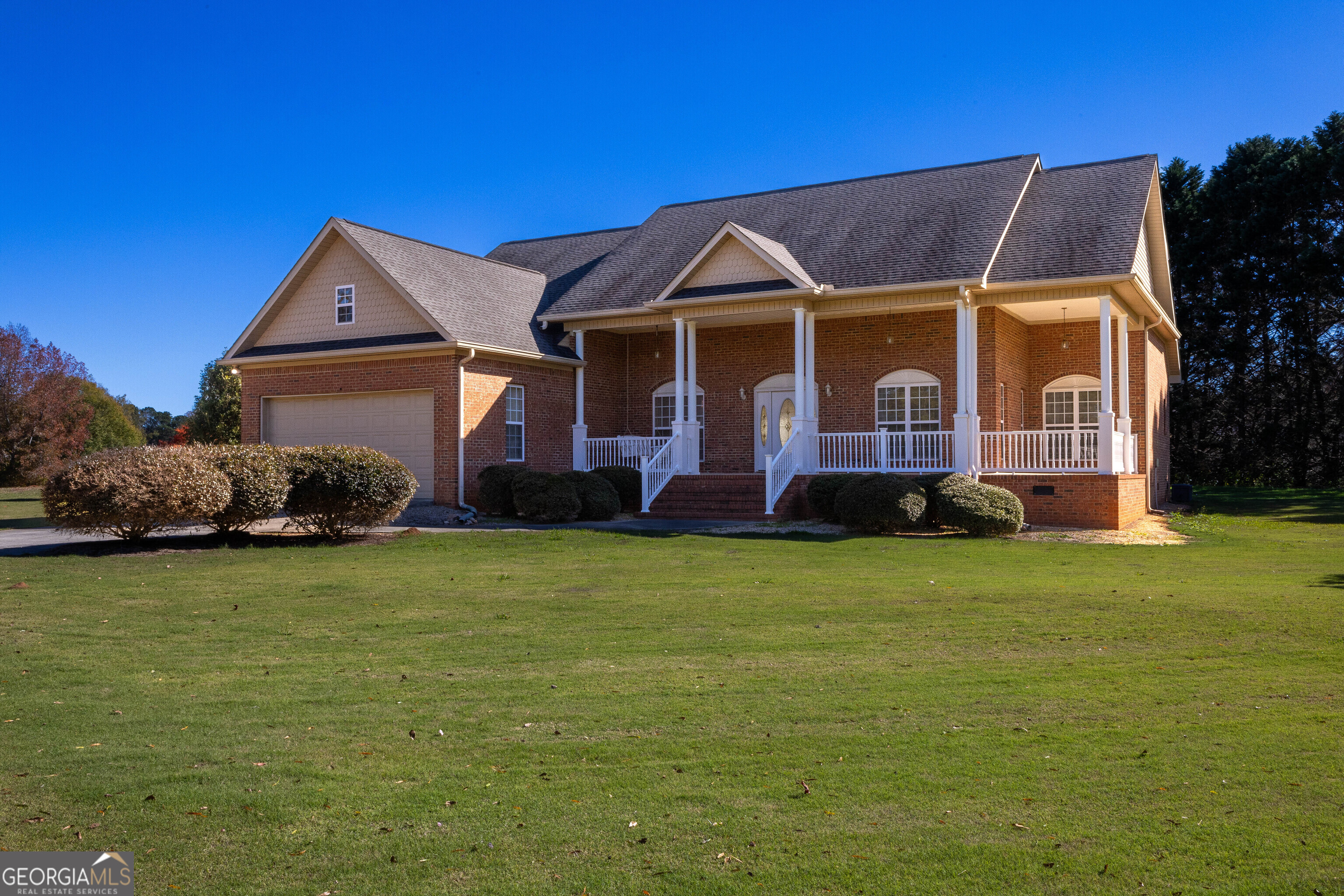 a front view of a house with a garden