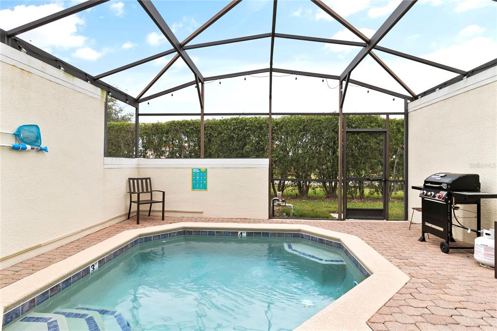 a swimming pool with mountain view and glass windows