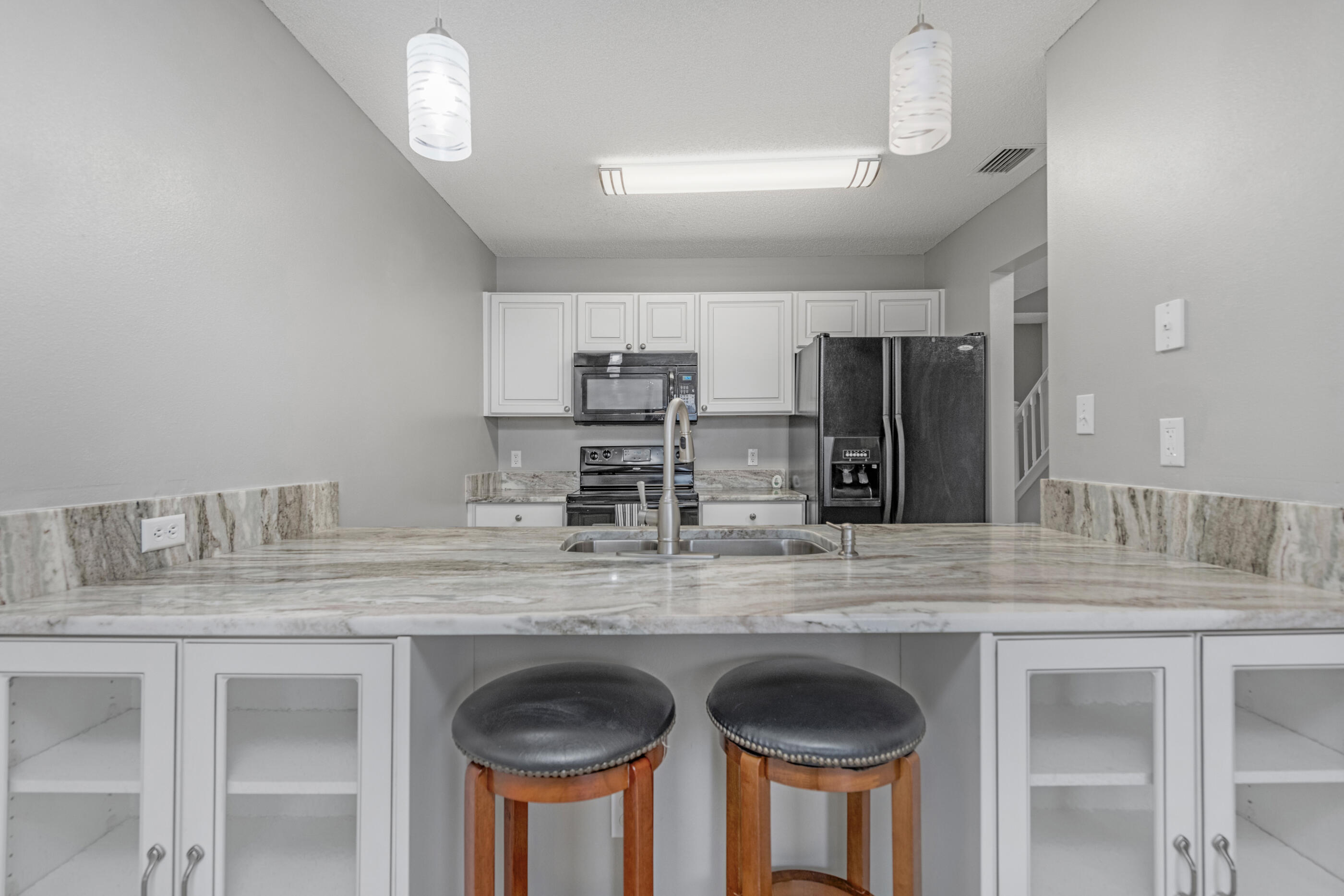 a kitchen with stainless steel appliances granite countertop a sink and cabinets