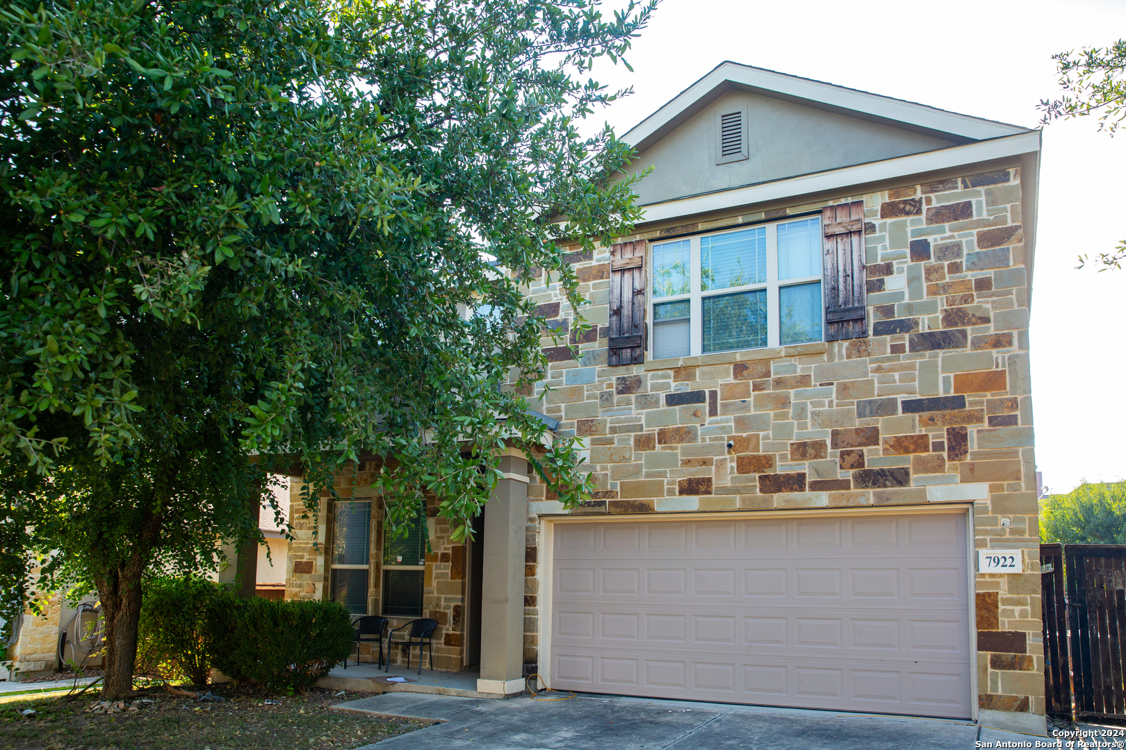 front view of a house with a tree