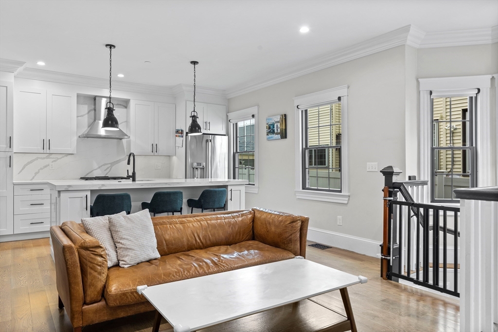 a living room with furniture kitchen and a window