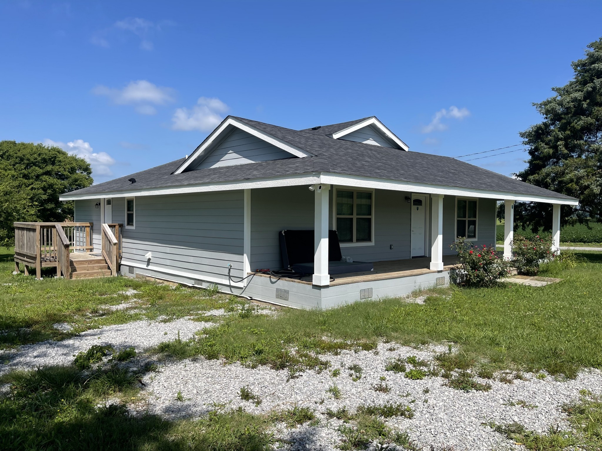 a front view of a house with a yard and porch