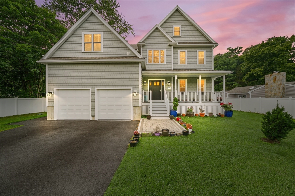 a front view of a house with a yard and garage