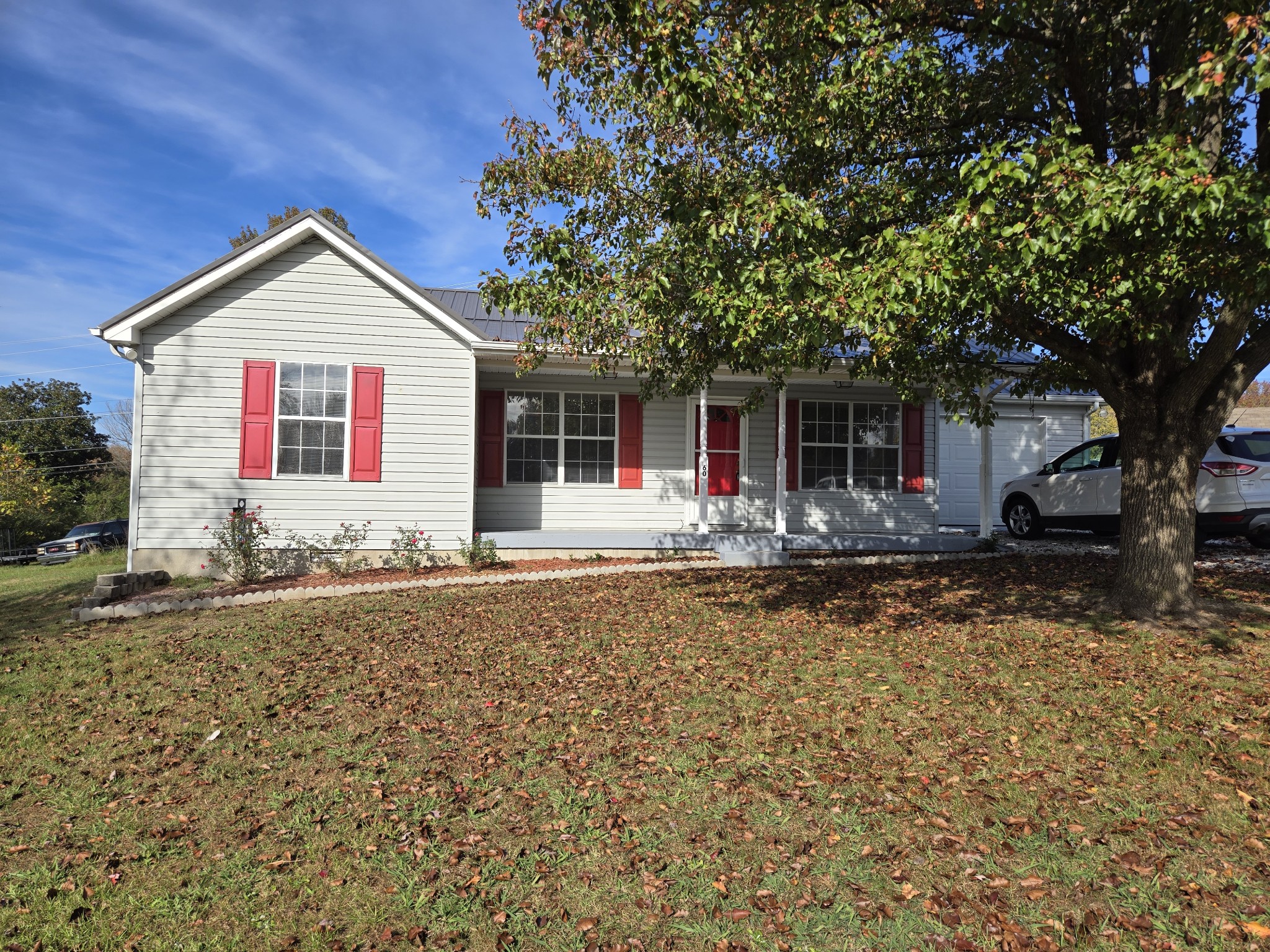 a front view of house with yard and trees