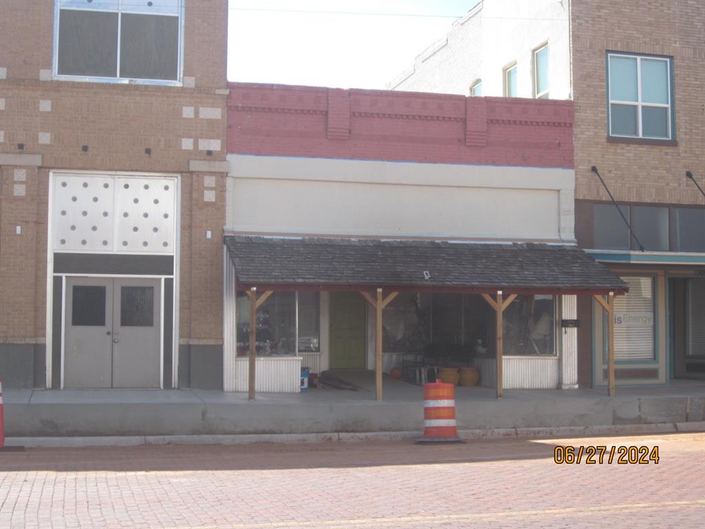 a front view of a building with parking