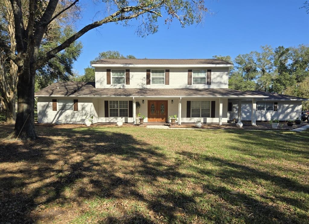 a front view of a house with a garden