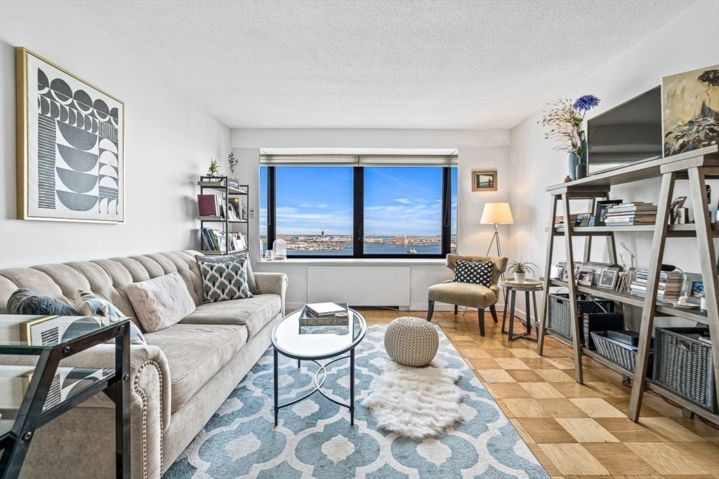 a living room with furniture a rug and a table