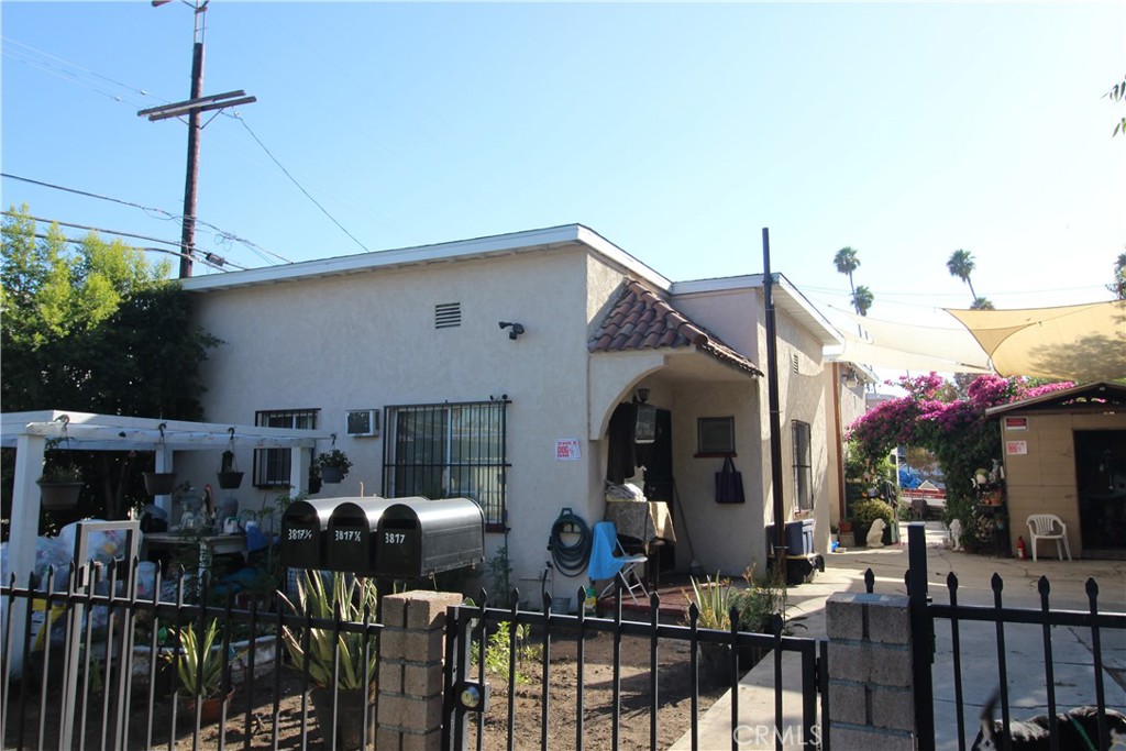 a front view of a house with outdoor seating