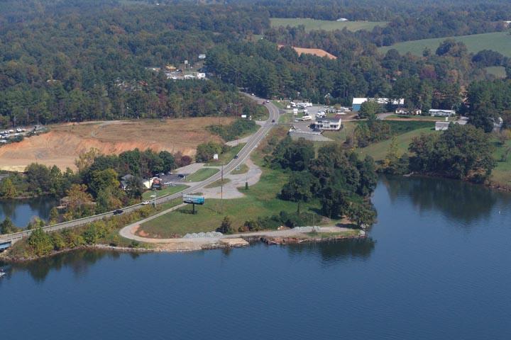 an aerial view of residential houses with outdoor space and lake view