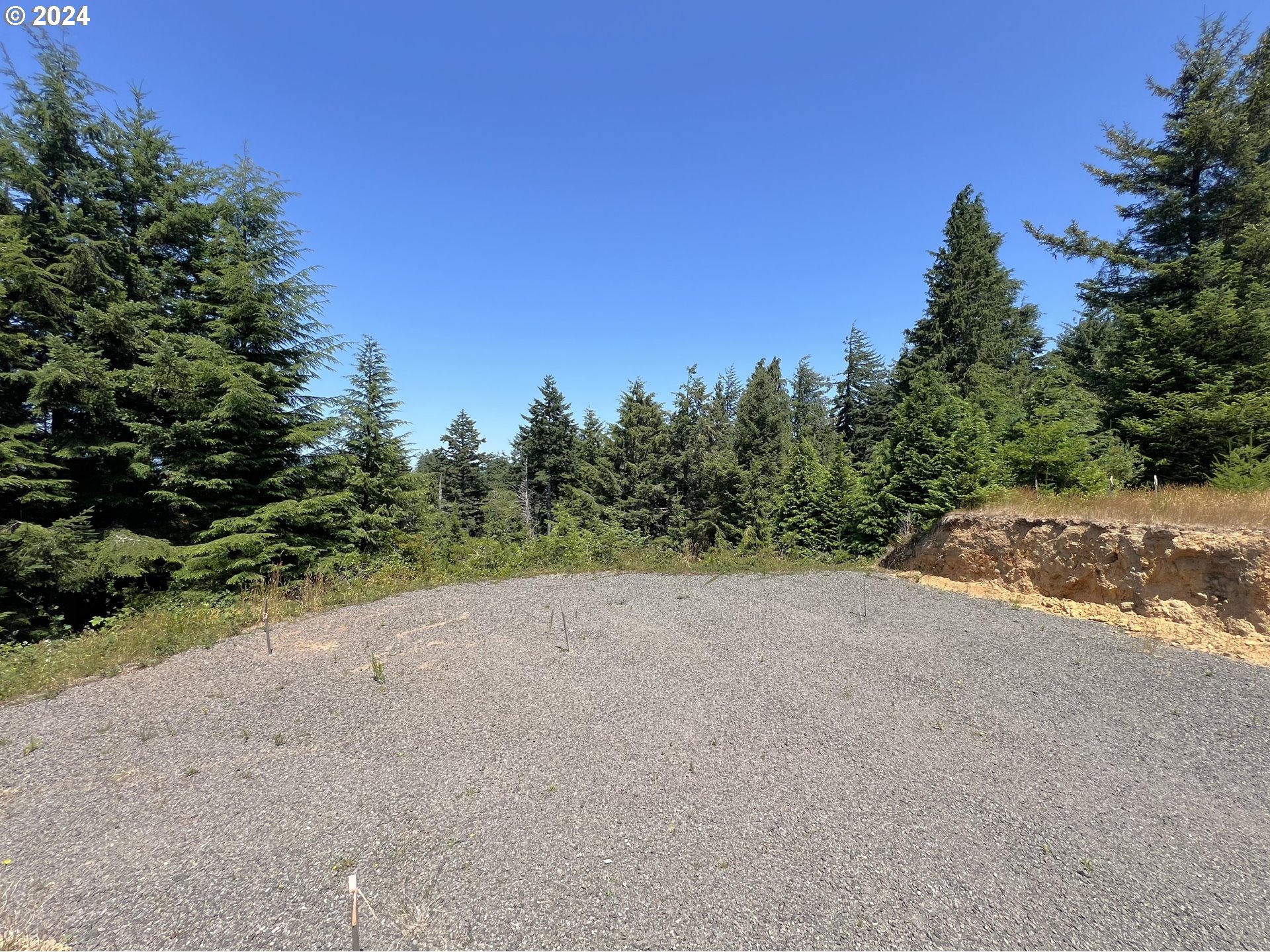 a view of a dirt road with a building in the background