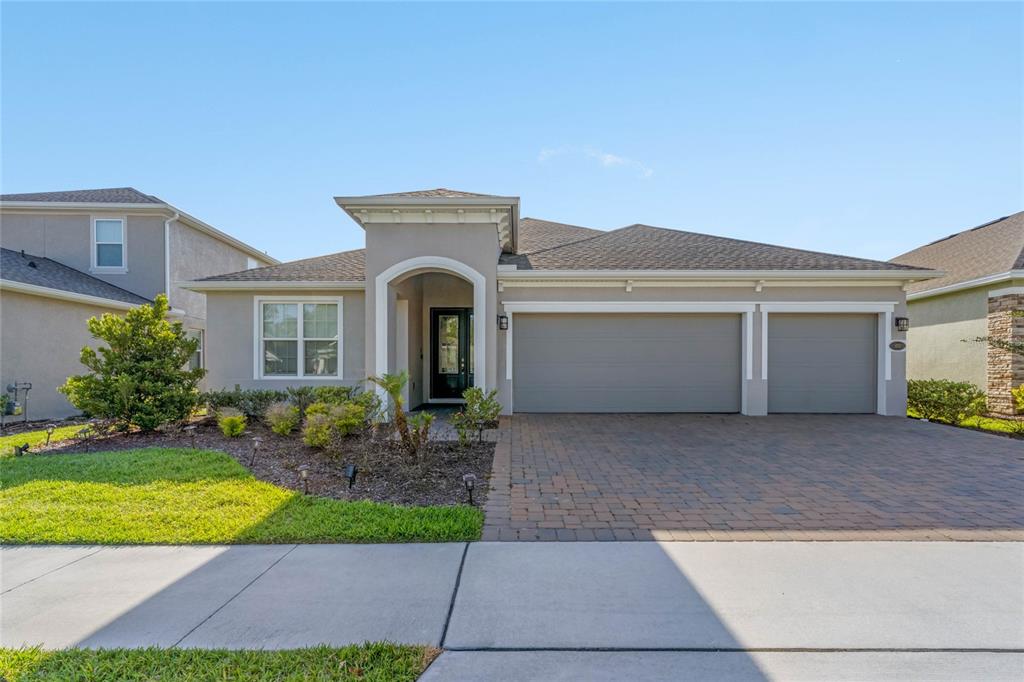 a front view of a house with a yard and garage