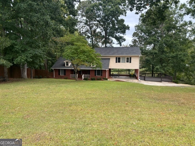 a front view of a house with a garden and tree